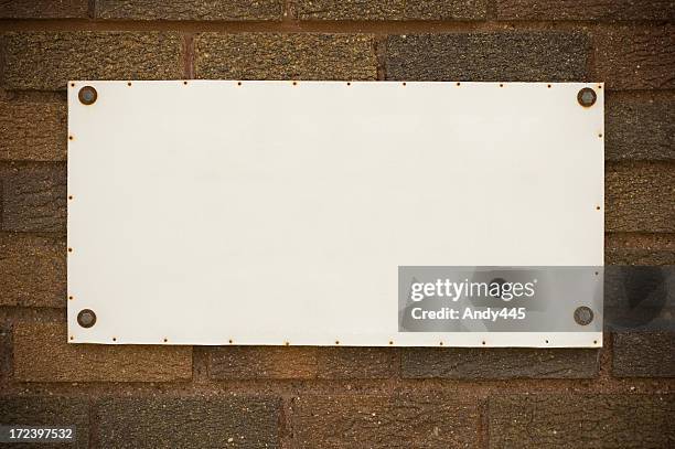 tablet on the brick wall - plaque stock pictures, royalty-free photos & images