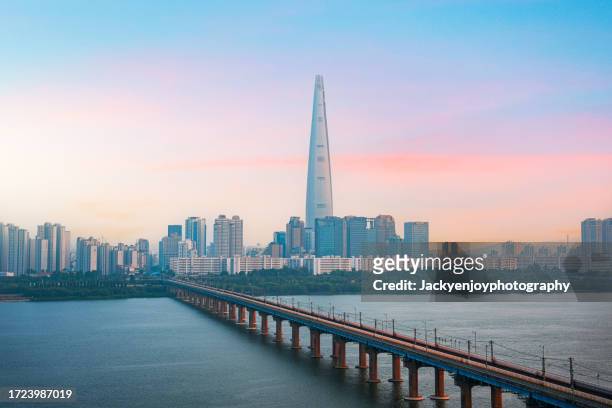 south korea's gyeonggi province bridge over a river with buildings against the sky - river han stock pictures, royalty-free photos & images