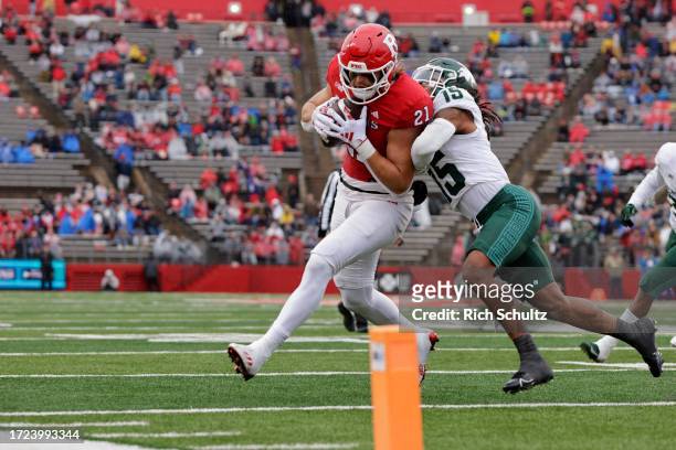 Tight end Johnny Langan of the Rutgers Scarlet Knights makes a catch and is defended by defensive back Angelo Grose of the Michigan State Spartans...
