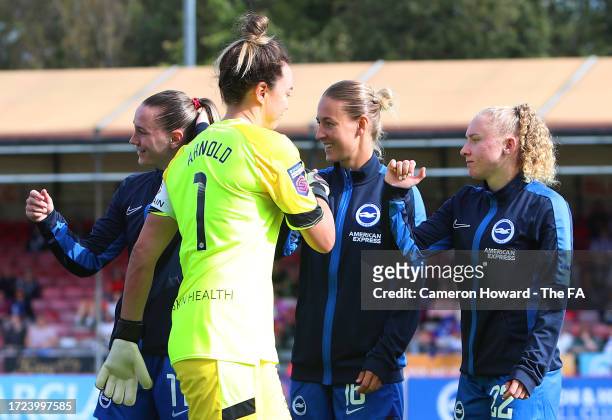 Mackenzie Arnold of West Ham United shakes hands with Brighton & Hove Albion players as the teams line up prior to the Barclays Women´s Super League...