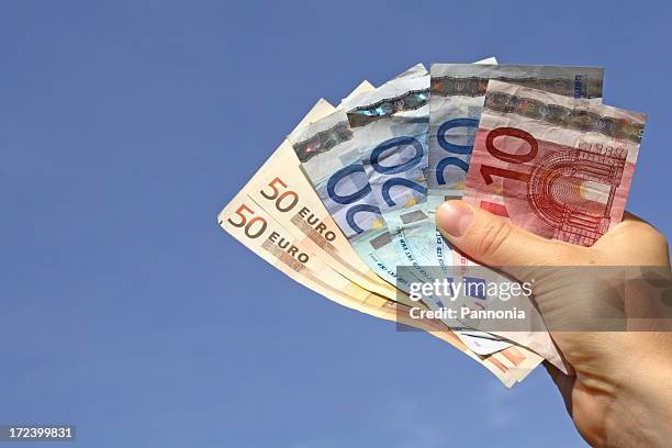 money in hand - euro in hand stock pictures, royalty-free photos & images