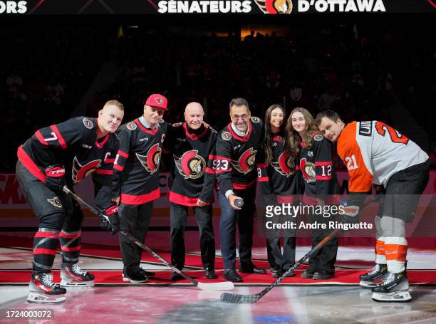 Bruce Firestone, Rod Dryden, Michael Andlauer, Olivia Melnyk and Anna Melnyk drop the puck for a ceremonial face-off between Brady Tkachuk of the...