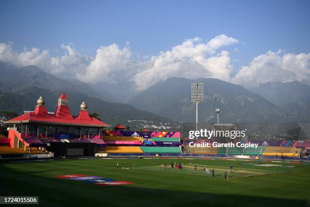 General view of the ground as the groundstaff prepare the pitch at Himachal Pradesh Cricket Association Stadium on October 08, 2023 in Dharamsala,...