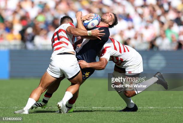 Juan Cruz Mallia of Argentina is tackled by Siosaia Fifita and Michael Leitch of Japan during the Rugby World Cup France 2023 match between Japan and...