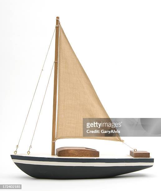 toy boat with a large brown sail - watervaartuig stockfoto's en -beelden