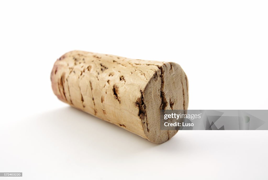Close up of a used wine cork on white background