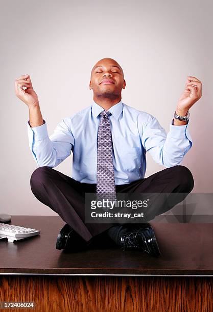 business meditation - businessman meditating stock pictures, royalty-free photos & images