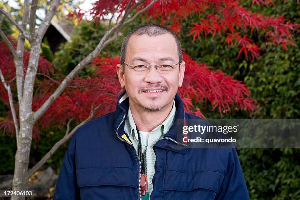 asian adult man in 40s smiling at camera, outdoor portrait - vietnamese ethnicity stock pictures, royalty-free photos & images
