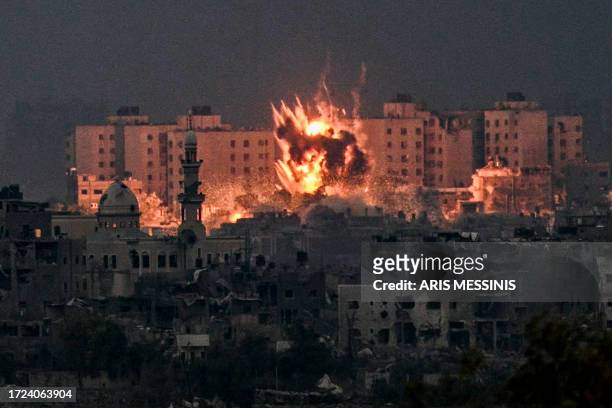 Fireball erupts during Israeli bombardment in the northern Gaza Strip on October 14, 2023. Thousands of people, both Israeli and Palestinians have...