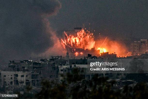 Fireball erupts during Israeli bombardment in the northern Gaza Strip on October 14, 2023. Thousands of people, both Israeli and Palestinians have...