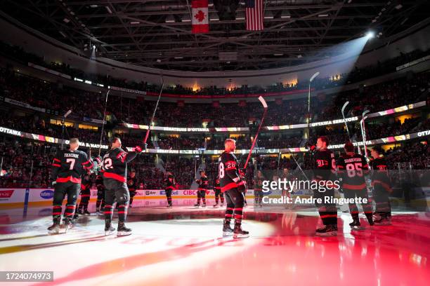 Brady Tkachuk, Thomas Chabot, Claude Giroux and Vladimir Tarasenko of the Ottawa Senators salute the crowd at centre ice during player introductions...
