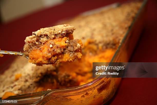 a spoonful of homemade sweet potato crunch - zoete aardappel stockfoto's en -beelden
