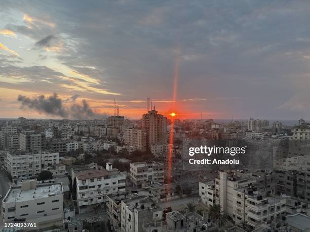 Smoke rises after Israeli attacks during the sunset in Gaza City, Gaza on October 14, 2023.