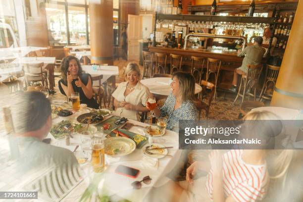 group of friends on a brunch in a restaurant - greek food imagens e fotografias de stock