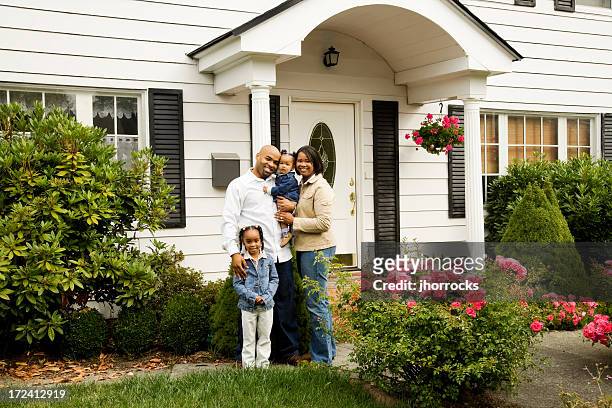 young family at home - family of four in front of house stock pictures, royalty-free photos & images