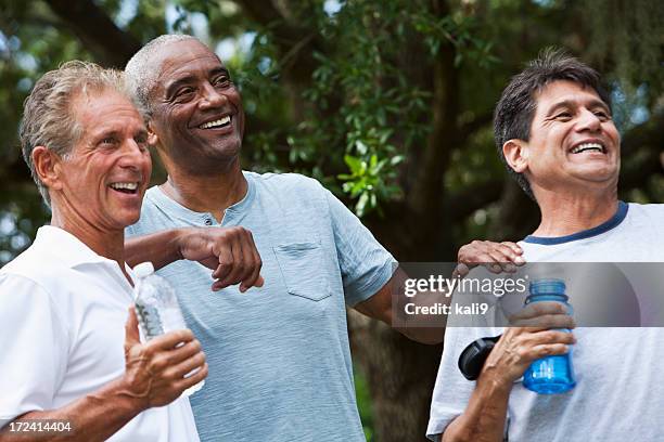 multi-ethnic men taking break from exercising - mature men group stock pictures, royalty-free photos & images