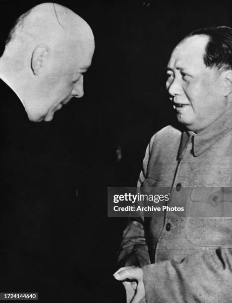 Polish politician Jozef Cyrankiewicz, Prime Minister of the Polish People's Republic, is greeted by Chinese politician Mao Zedong during a visit to...