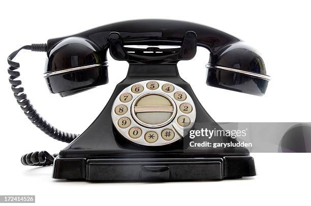 shiny black retro finger dial telephone on white background - vintage telephone stock pictures, royalty-free photos & images