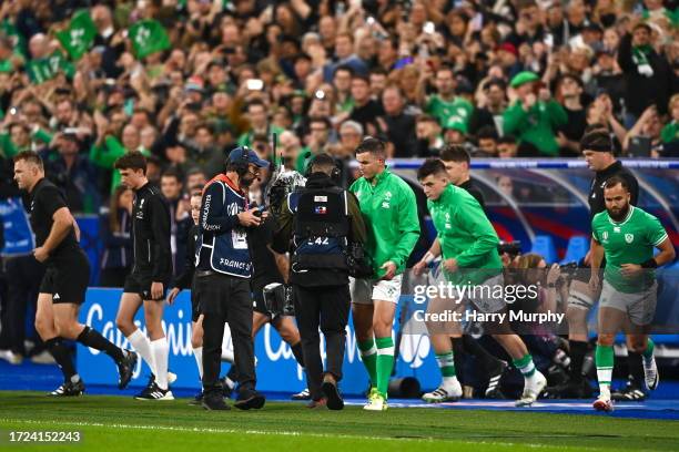 Paris , France - 14 October 2023; Jonathan Sexton of Ireland collides with a roving camera operator as he leads his team out before the 2023 Rugby...