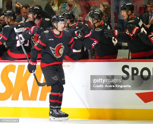 Jake Sanderson of the Ottawa Senators celebrates his first goal of the season during a game against the Philadelphia Flyers with teammates at the...