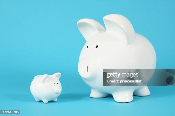 a big piggy bank and a smaller one - mini stock pictures, royalty-free photos & images