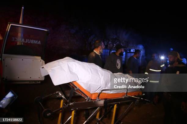 Paramedics carry the bodies of those killed in the Israeli attack on the town of Shebaa in southern Lebanon to the ambulance in Nabatieh Governorate,...