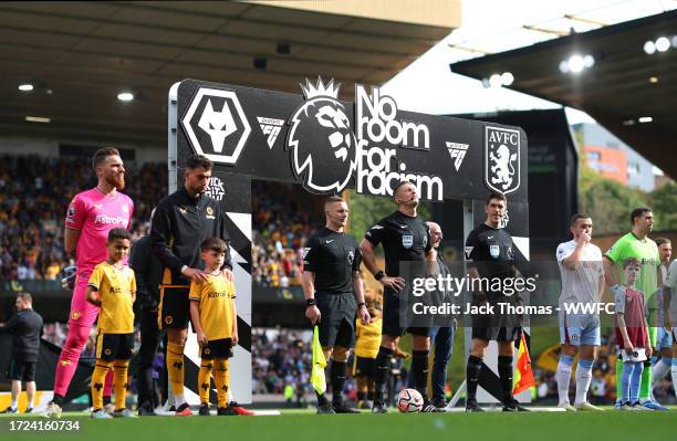 Jose Sa of Wolverhampton Wanderers lines up with match officials in front of the 'No room for racism' banner prior to the Premier League match...