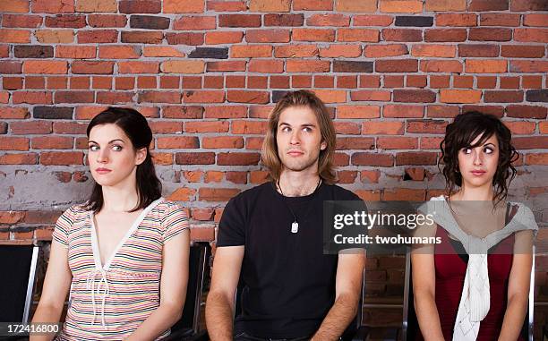 a man and two women waiting together - twohumans bildbanksfoton och bilder