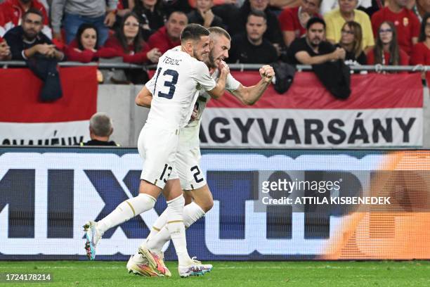 Serbia's defender Strahinja Pavlovic celebrates scoring the 1-1 goal with his team-mate Serbia's midfielder Aleksa Terzic during the UEFA Euro 2024...