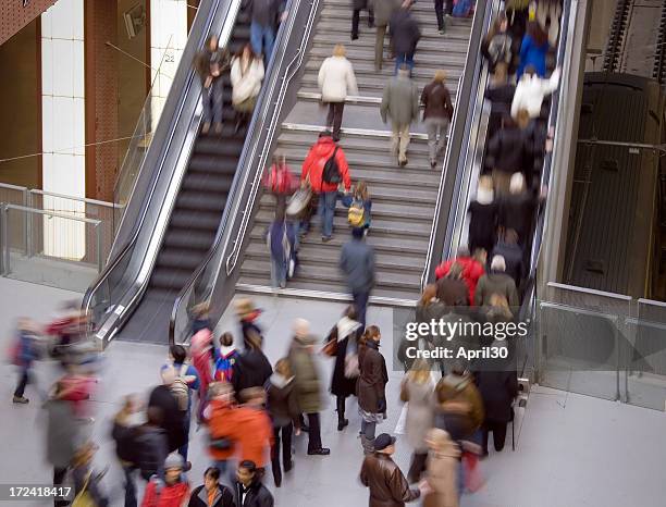 commuters in a railroad station - escalator stockfoto's en -beelden