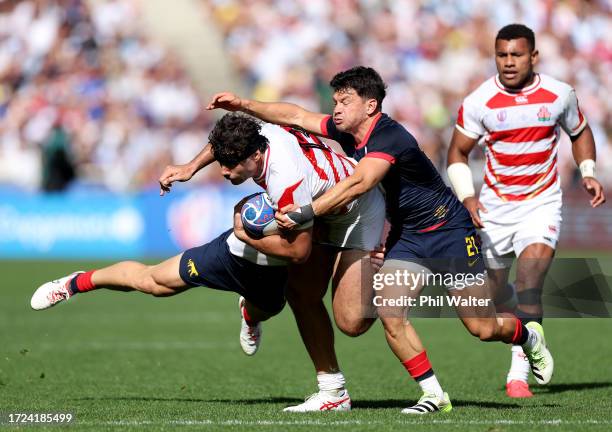 Dylan Riley of Japan is tackled by Mateo Carreras and Lautaro Bazan Velez of Argentina during the Rugby World Cup France 2023 match between Japan and...