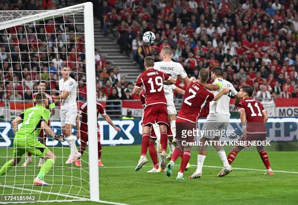 Serbia's defender Strahinja Pavlovic gets up to head the ball scoring the 1-1 goal past Hungary's goalkeeper Denes Dibusz during the UEFA Euro 2024...