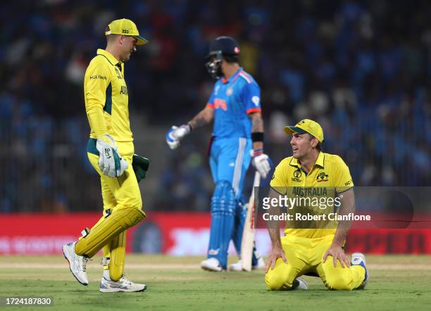 Mitch Marsh of Australia reacts with teammate Alex Carey after dropping a catch from Virat Kohli of India during the ICC Men's Cricket World Cup...