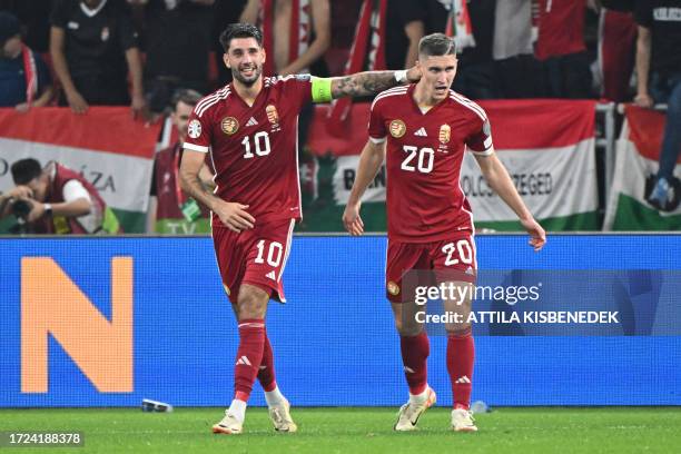 Hungary's forward Roland Sallai celebrates scoring the 2-1 goal with his team-mate Hungary's forward Dominik Szoboszlai during the UEFA Euro 2024...