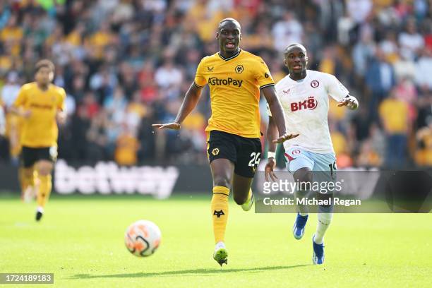Toti Gomes of Wolverhampton Wanderers runs ahead of Moussa Diaby of Aston Villa during the Premier League match between Wolverhampton Wanderers and...