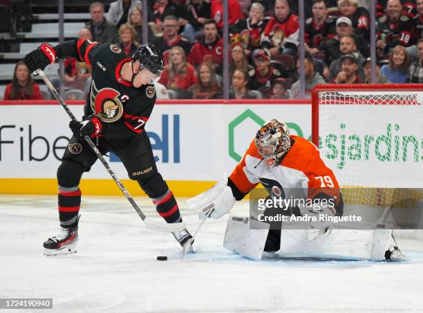 Brady Tkachuk of the Ottawa Senators controls the puck in front of Carter Hart of the Philadelphia Flyers at Canadian Tire Centre on October 14, 2023...