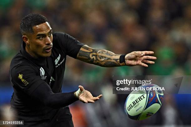 New Zealand's scrum-half Aaron Smith passes the ball during the France 2023 Rugby World Cup quarter-final match between Ireland and New Zealand at...