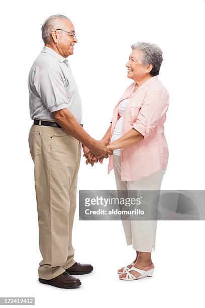 loving senior couple holding hands - interracial wife stockfoto's en -beelden