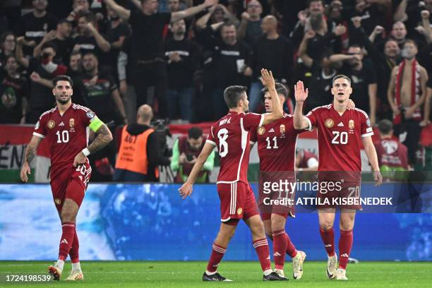 Hungary's forward Roland Sallai celebrates scoring the 2-1 goal with his team-mates during the UEFA Euro 2024 Group G qualification football match...