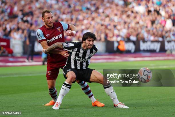 Sandro Tonali of Newcastle United is challenged by Vladimir Coufal of West Ham United during the Premier League match between West Ham United and...