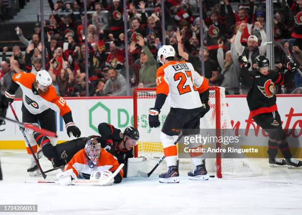 Brady Tkachuk of the Ottawa Senators scores a third period goal against Carter Hart of the Philadelphia Flyers at Canadian Tire Centre on October 14,...
