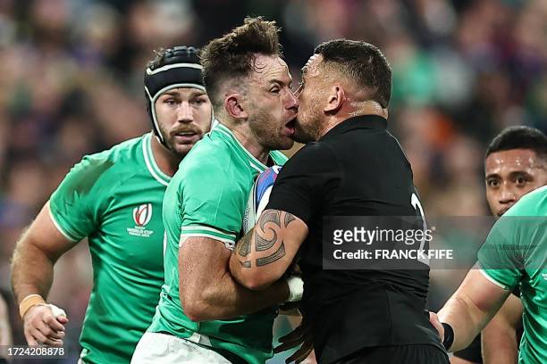 Ireland's full-back Hugo Keenan and New Zealand's hooker Codie Taylor fight for the ball during the France 2023 Rugby World Cup quarter-final match...