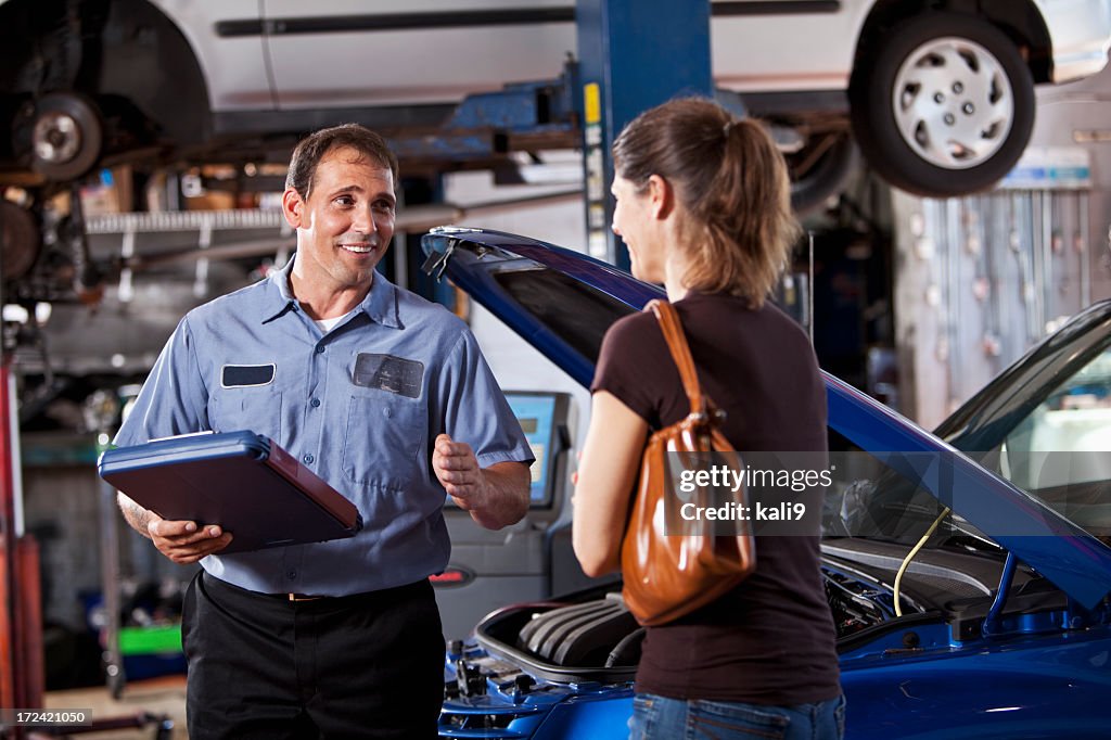 Auto mechanic with customer