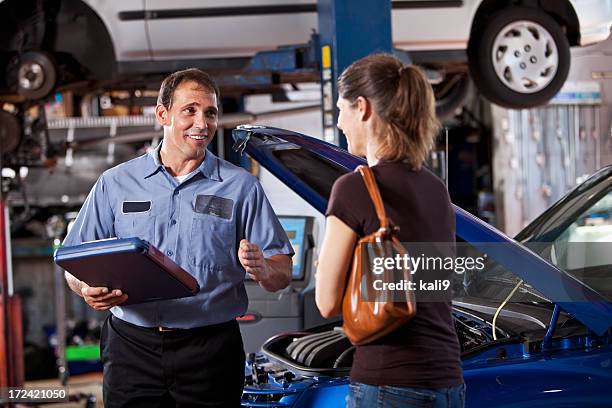 auto mechanic with customer - mechanics talking stock pictures, royalty-free photos & images