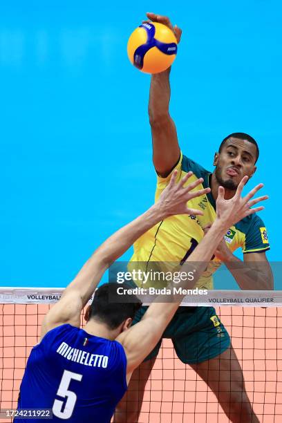 Lucarelli of Brazil jumps to spike the ball against Alessandro Michieletto of Italy during the men's Olympic qualifying tournament 2023 volleyball...