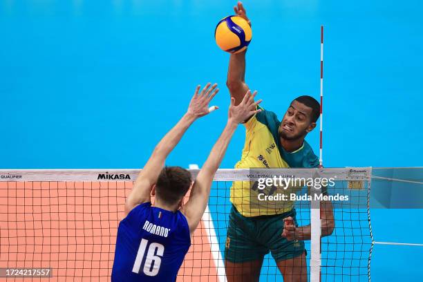 Lucarelli of Brazil jumps to spike the ball against Yuri Romanò of Italy during the men's Olympic qualifying tournament 2023 volleyball match between...