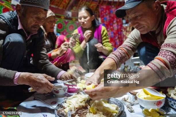 ethnic kazakh family having besbarmak inside ger, mongolia - kazakhstan culture stock pictures, royalty-free photos & images
