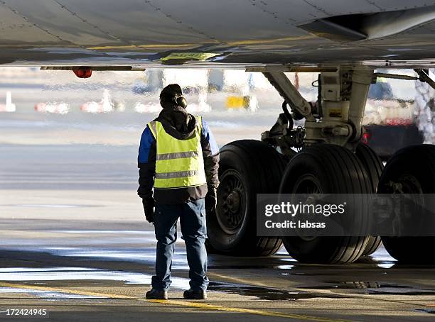 ground crew preparing big jet for take off - airport crew stock pictures, royalty-free photos & images