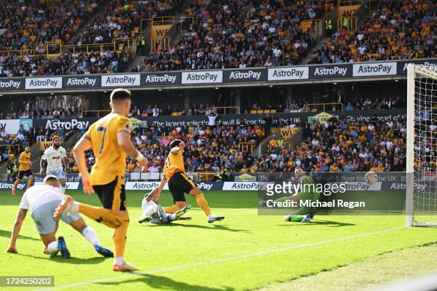 Hwang Hee-Chan of Wolverhampton Wanderers scores their sides first goal during the Premier League match between Wolverhampton Wanderers and Aston...