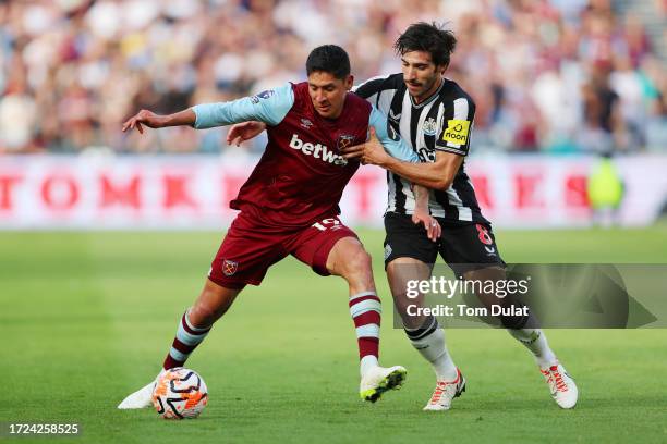 Edson Alvarez of West Ham United is challenged by Sandro Tonali of Newcastle United during the Premier League match between West Ham United and...